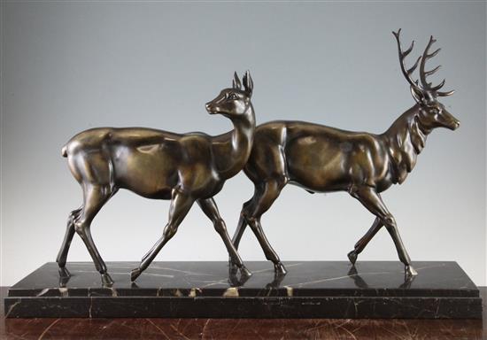 A French Art Deco patinated metal figure group of a stag and doe, 27.5in.